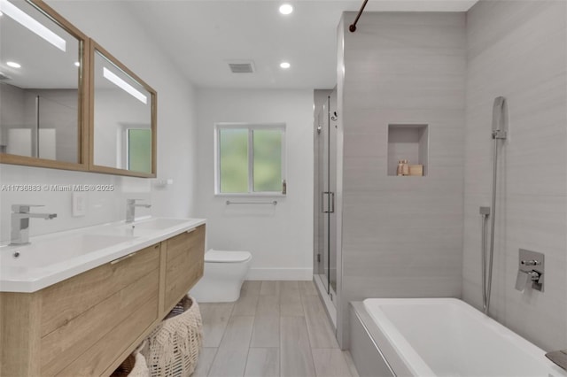 full bathroom featuring vanity, separate shower and tub, and toilet