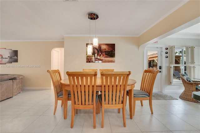 dining room with ornamental molding and light tile patterned floors