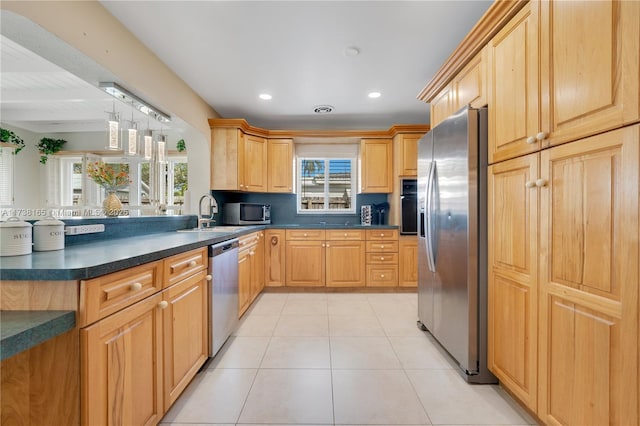 kitchen featuring sink, light brown cabinets, light tile patterned flooring, and appliances with stainless steel finishes