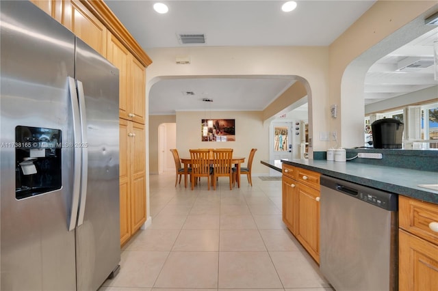 kitchen with stainless steel appliances, a wealth of natural light, pendant lighting, and light tile patterned floors