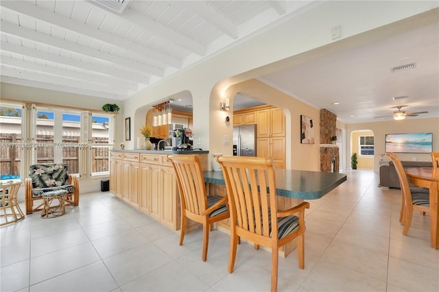 dining space featuring wood ceiling, beam ceiling, and light tile patterned floors