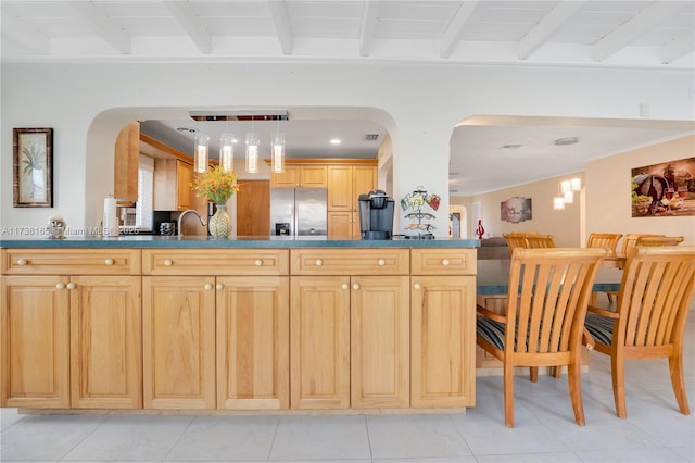 kitchen featuring sink, beam ceiling, stainless steel fridge with ice dispenser, and light brown cabinets