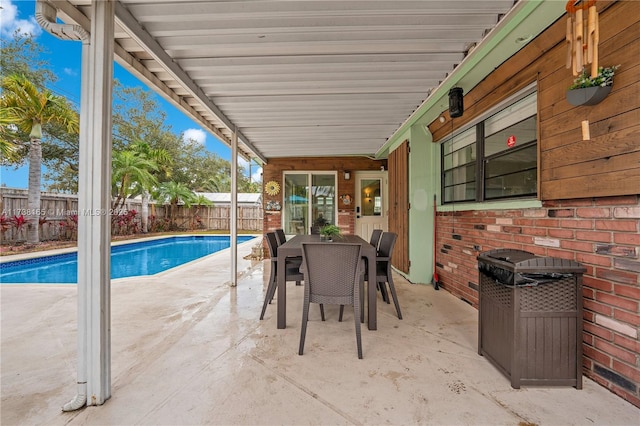 view of patio / terrace with a fenced in pool