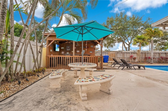 view of patio with a fenced in pool