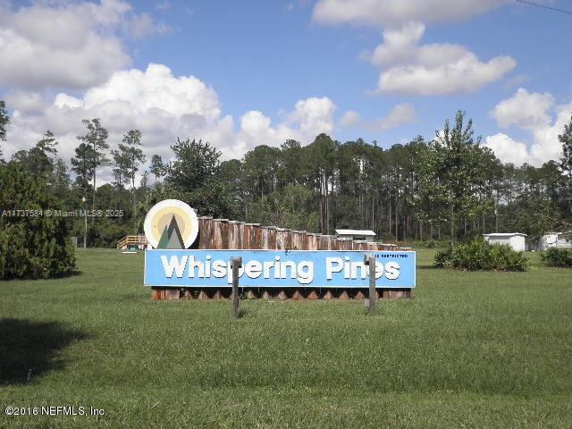 community sign featuring a lawn