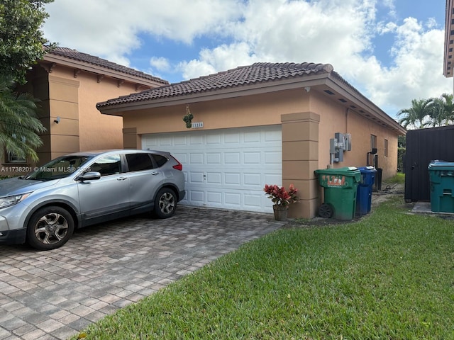 view of side of home featuring a yard and a garage