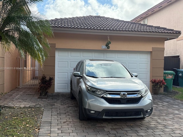 garage with decorative driveway