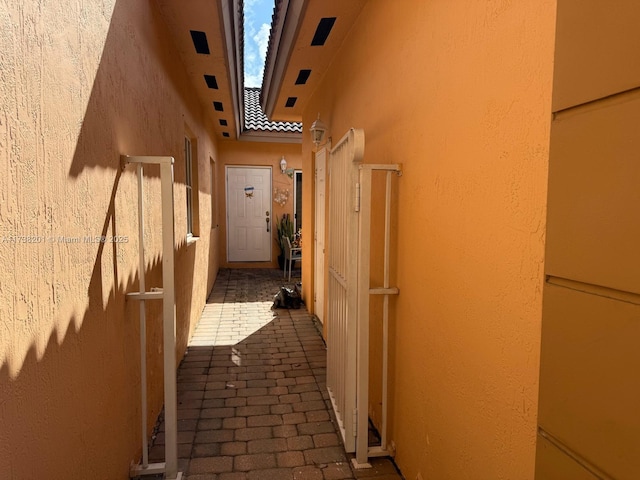 exterior space featuring a tiled roof and stucco siding