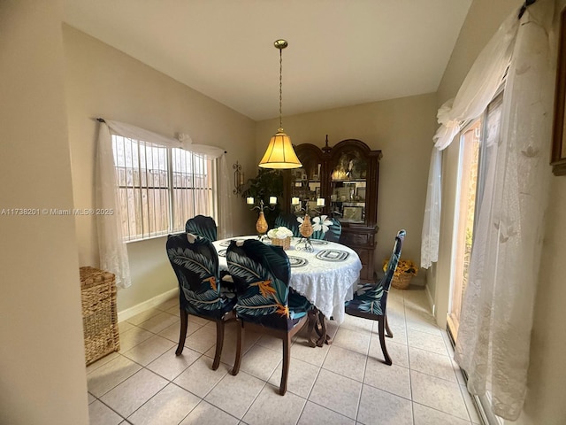 dining area featuring light tile patterned floors and baseboards