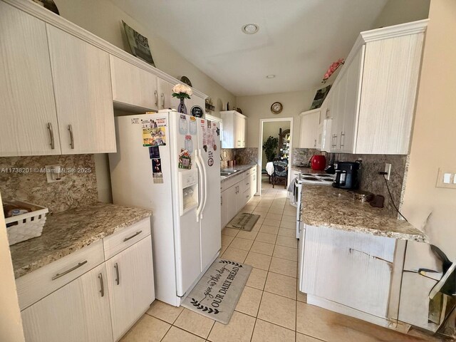 11224 SW 231st Ln, Miami, FL 33170 - kitchen with white appliances, decorative backsplash, light tile patterned floors, and light stone countertops