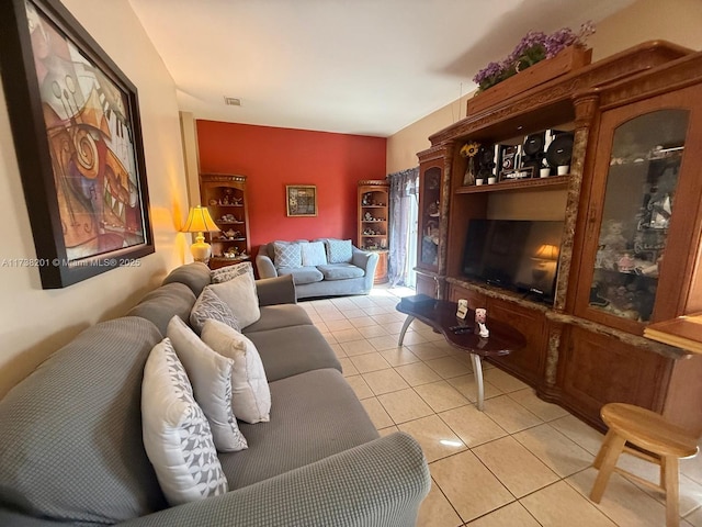 living area featuring light tile patterned floors and visible vents