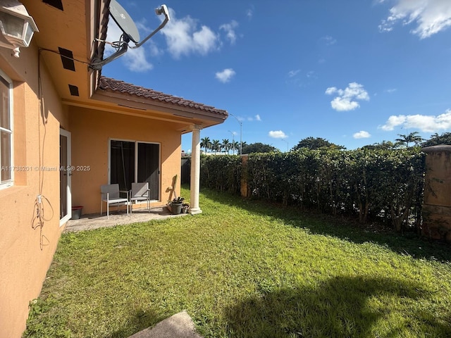 view of yard featuring a patio area and a fenced backyard