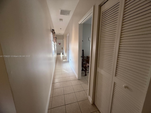 corridor with light tile patterned flooring