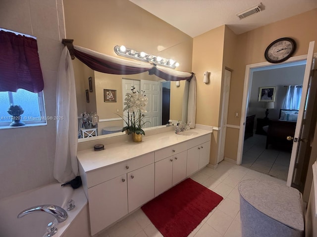 bathroom with tile patterned flooring and vanity