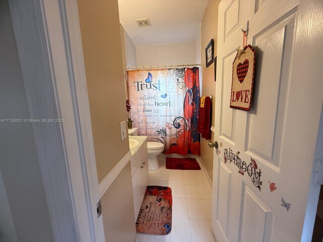 bathroom with tile patterned flooring, vanity, a shower with curtain, and toilet