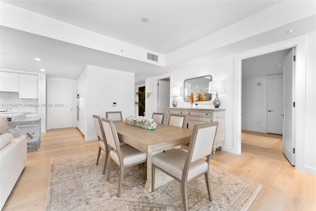 dining space with light wood-type flooring