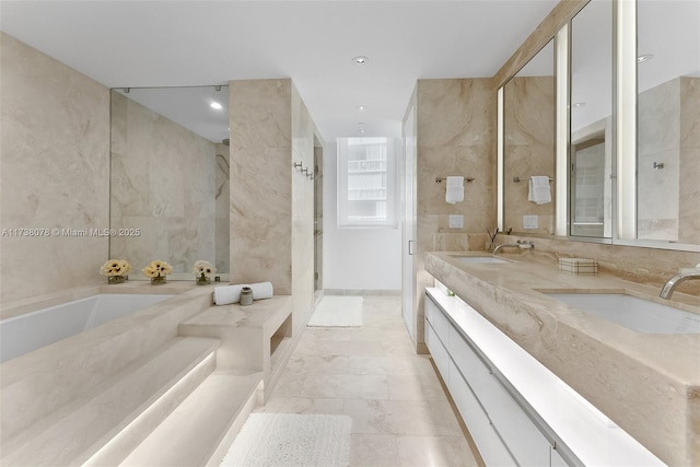 bathroom featuring vanity, shower with separate bathtub, and tile walls