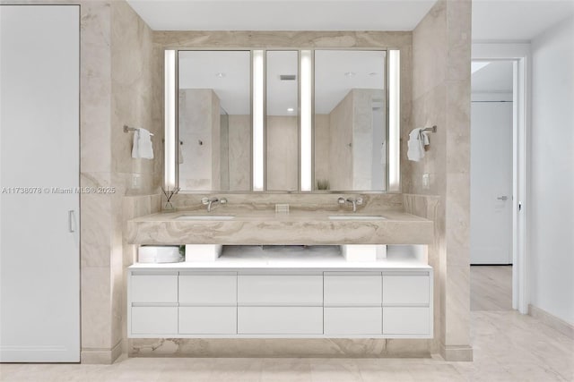 bathroom featuring vanity and tile walls