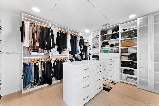 spacious closet featuring light hardwood / wood-style floors