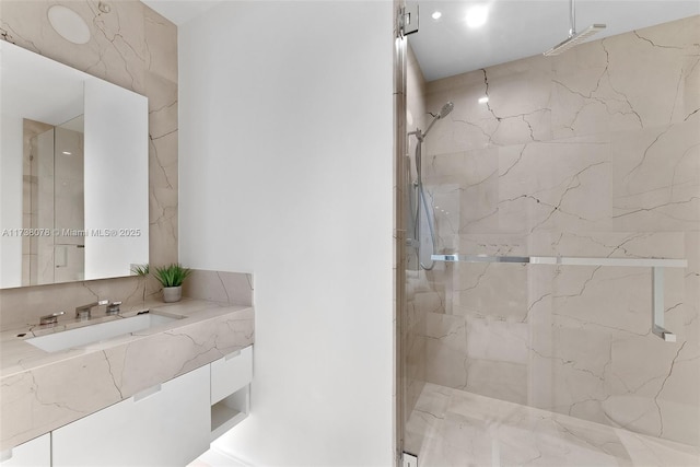 bathroom with vanity and tiled shower