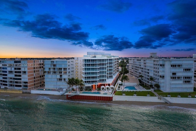 outdoor building at dusk featuring a water view