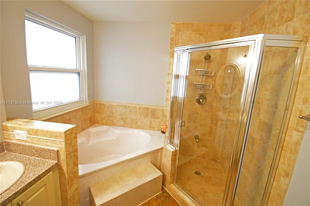 bathroom featuring vanity and separate shower and tub