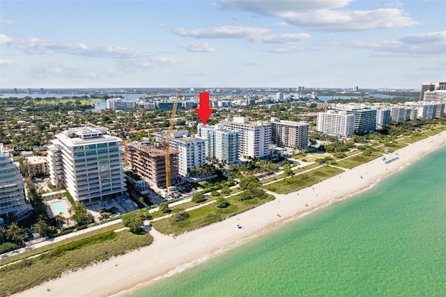 drone / aerial view with a water view and a beach view