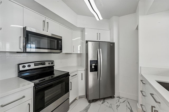 kitchen featuring stainless steel appliances and white cabinets