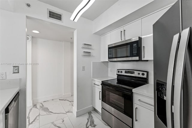 kitchen with white cabinetry and appliances with stainless steel finishes