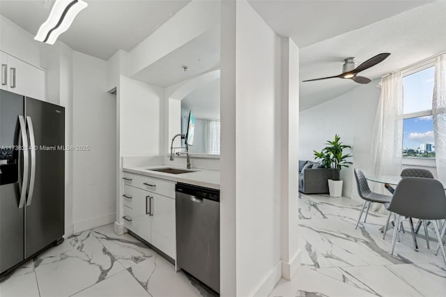 kitchen featuring white cabinetry, sink, stainless steel appliances, and ceiling fan