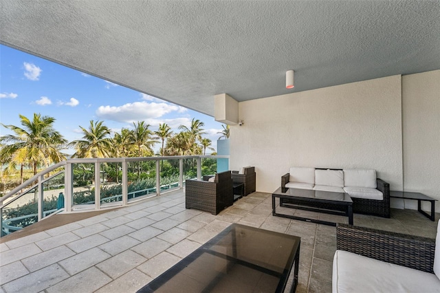 view of patio featuring a balcony and an outdoor hangout area