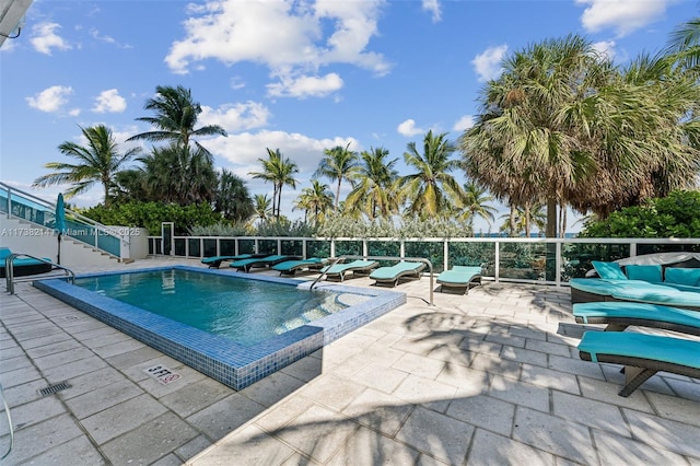 view of swimming pool featuring a patio area