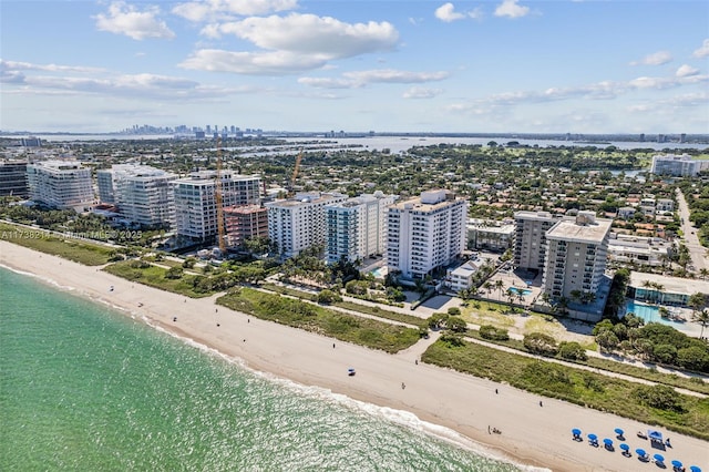 bird's eye view featuring a water view and a beach view