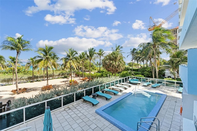 view of swimming pool featuring a patio area