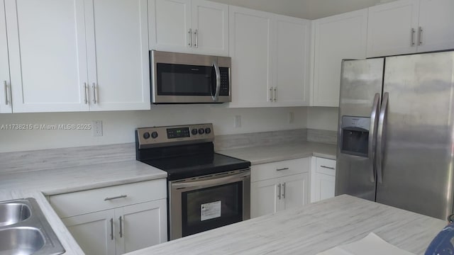 kitchen featuring white cabinetry and appliances with stainless steel finishes