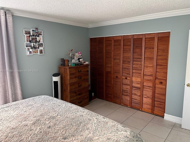 bedroom with light tile patterned flooring, a closet, crown molding, and a textured ceiling