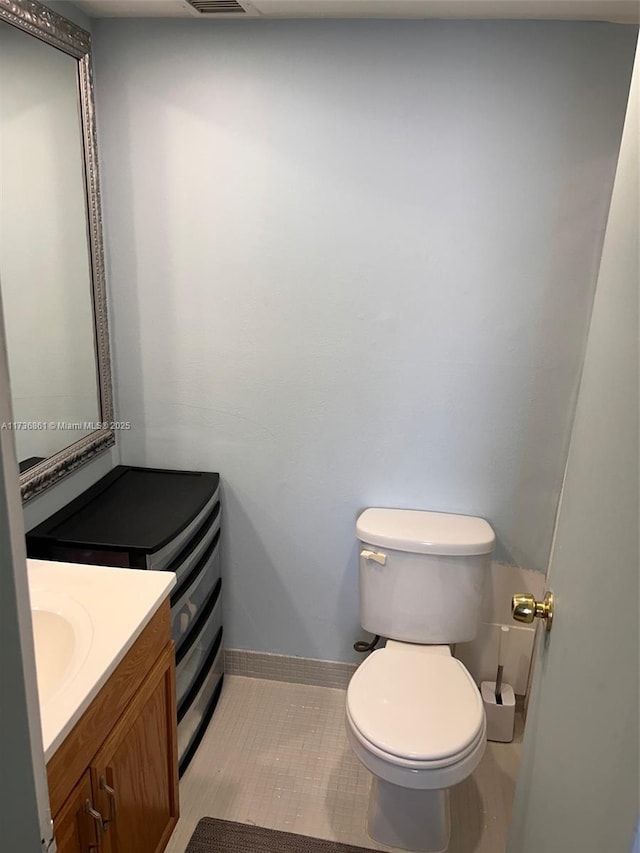 bathroom with tile patterned floors, vanity, and toilet