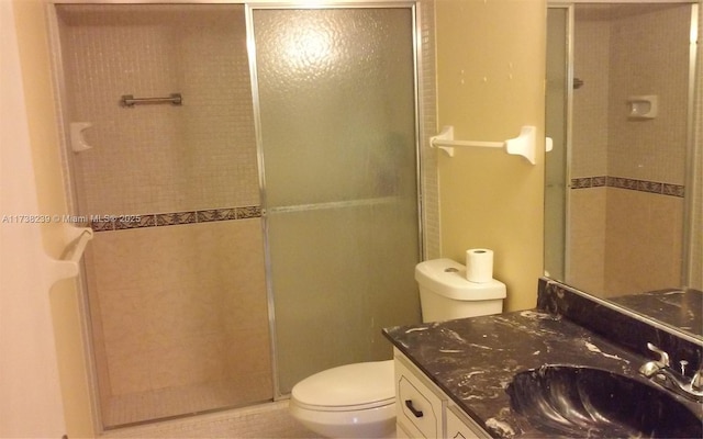 bathroom with vanity, toilet, and an enclosed shower