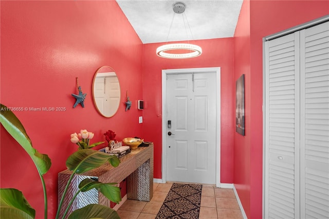 foyer entrance featuring light tile patterned flooring