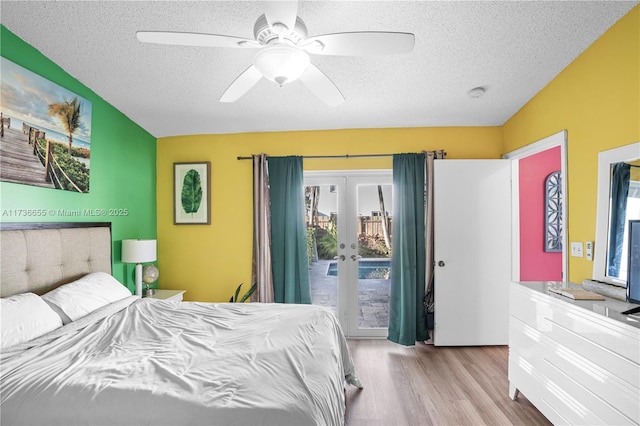 bedroom with light hardwood / wood-style flooring, access to outside, french doors, and a textured ceiling