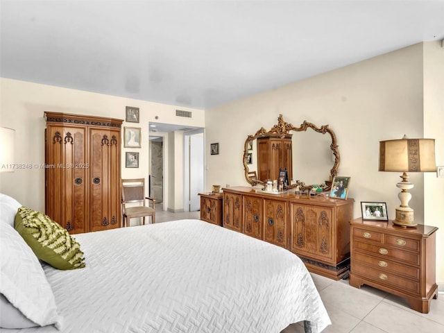 bedroom with light tile patterned floors and visible vents