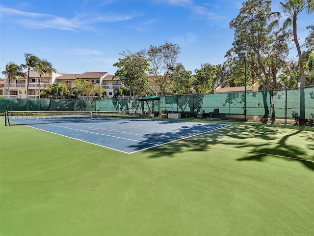 view of tennis court featuring fence