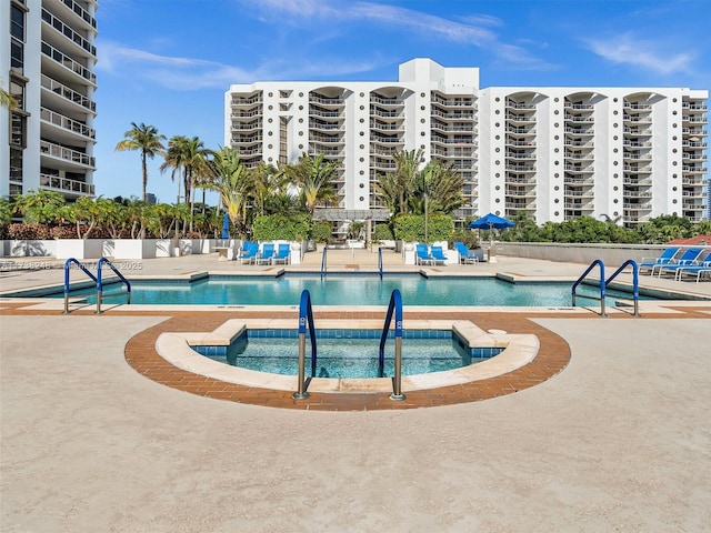 pool with a community hot tub and a patio