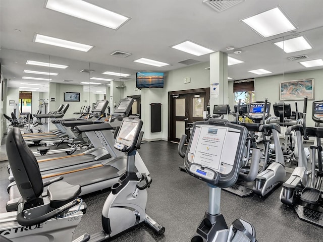 exercise room featuring a healthy amount of sunlight and visible vents