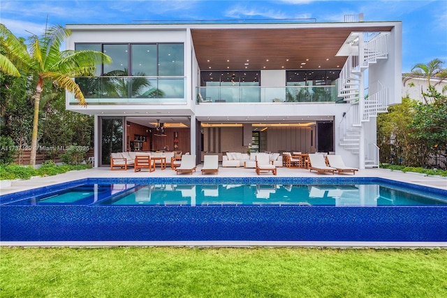 back of house with an outdoor living space and a patio