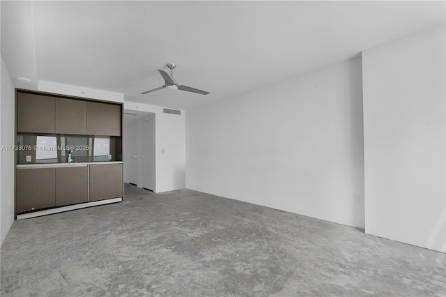 unfurnished living room with ceiling fan