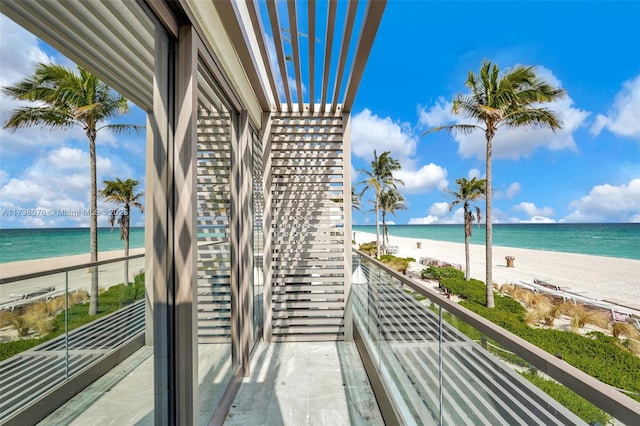 balcony with a view of the beach and a water view