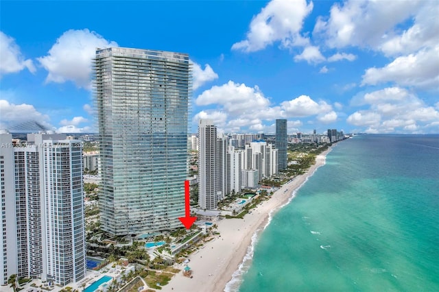 drone / aerial view with a beach view and a water view