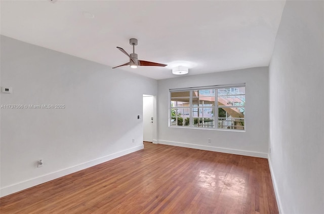 empty room with hardwood / wood-style flooring and ceiling fan