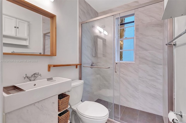 bathroom featuring vanity, a shower with shower door, and toilet